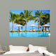 Swimming pool with  umbrellas on beach in Mauritius Wall Mural