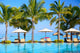 Swimming pool with  umbrellas on beach in Mauritius Wall Mural