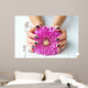 Hands with stylish dark manicure and pink flower 