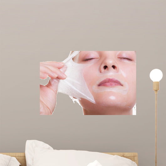 Portrait blond girl in facial mask. Beauty and skin care. 