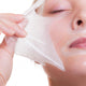 Portrait blond girl in facial mask. Part face. Beauty skin care. 