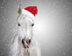 White christmas horse with santa hat on gray background snowfall 