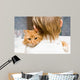 The red cat sitting on a shoulder at the child 