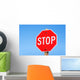 Stop sign on a road Wall Mural