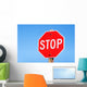 Stop sign on a road Wall Mural