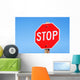 Stop sign on a road Wall Mural