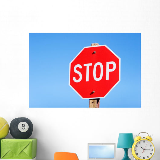Stop sign on a road Wall Mural