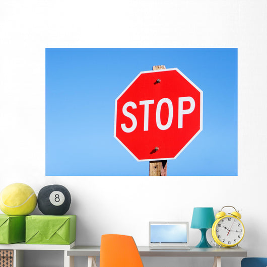 Stop sign on a road Wall Mural