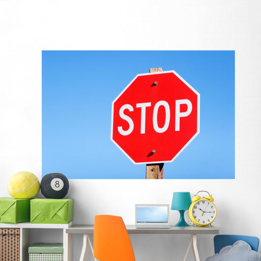Stop sign on a road Wall Mural