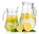 Cold water with lime, lemon and ice in pitchers isolated 