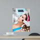 Woman getting laser face treatment in medical spa center 