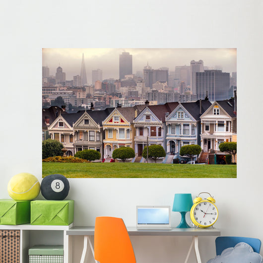 The Painted Ladies of San Francisco, California sit glowing amid Wall Mural