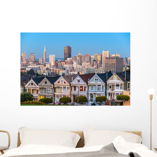 The Painted Ladies of San Francisco, California sit glowing amid Wall Mural