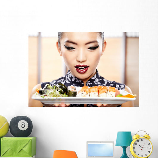 Beautiful young woman eating sushi. Shallow depth of field, focu 