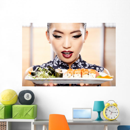 Beautiful young woman eating sushi. Shallow depth of field, focu 