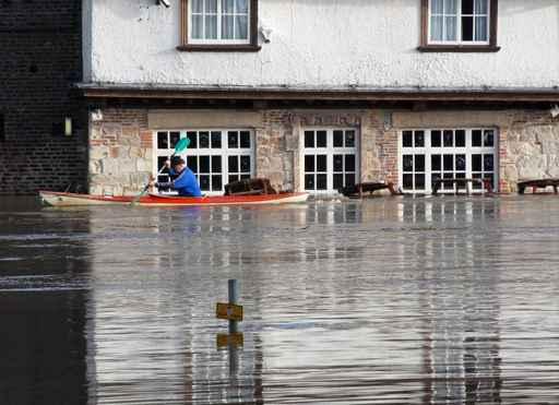 Canoeist Paddles past Flooded Wall Decal