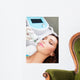 Woman getting laser face treatment in medical spa center 