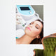 Woman getting laser face treatment in medical spa center 
