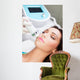 Woman getting laser face treatment in medical spa center 