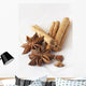 Star anise and cinnamon sticks, on a beige linen napkin. Wall Mural