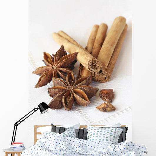 Star anise and cinnamon sticks, on a beige linen napkin. Wall Mural