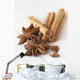 Star anise and cinnamon sticks, on a beige linen napkin. Wall Mural