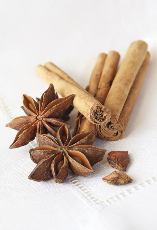Star anise and cinnamon sticks, on a beige linen napkin. Wall Mural