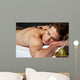 Man relaxing on a massage bed with hot stones Wall Mural