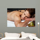 Man relaxing on a massage bed with hot stones Wall Mural
