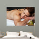 Man relaxing on a massage bed with hot stones Wall Mural