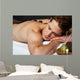 Man relaxing on a massage bed with hot stones Wall Mural