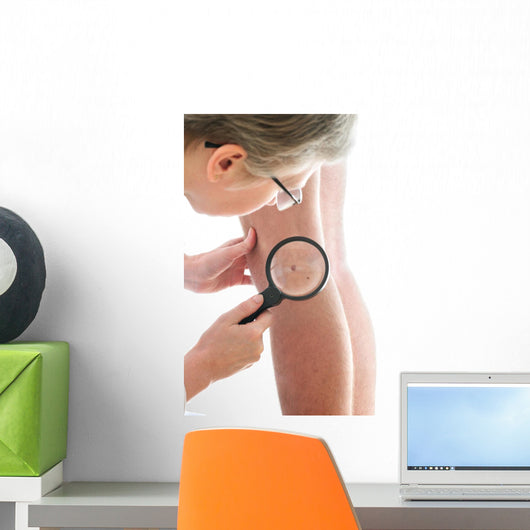 Dermatologist examines a mole Wall Mural