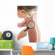 Dermatologist examines a mole Wall Mural