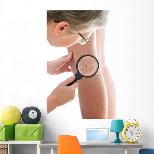 Dermatologist examines a mole Wall Mural
