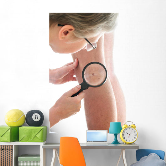 Dermatologist examines a mole Wall Mural