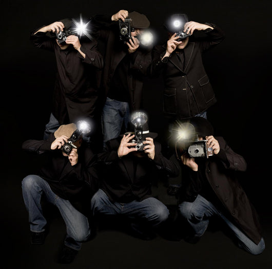 Retro style paparazzi press photographers with vintage cameras Wall Mural