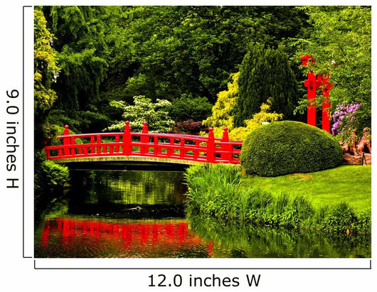 Red Bridge over a Lake in Green Japanese Garden 