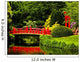 Red Bridge over a Lake in Green Japanese Garden 