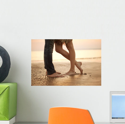 A loving young couple hugging and kissing on the beach. Lovers m Wall Mural