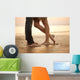 A loving young couple hugging and kissing on the beach. Lovers m Wall Mural