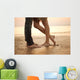 A loving young couple hugging and kissing on the beach. Lovers m Wall Mural