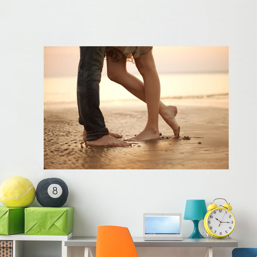 A loving young couple hugging and kissing on the beach. Lovers m Wall Mural
