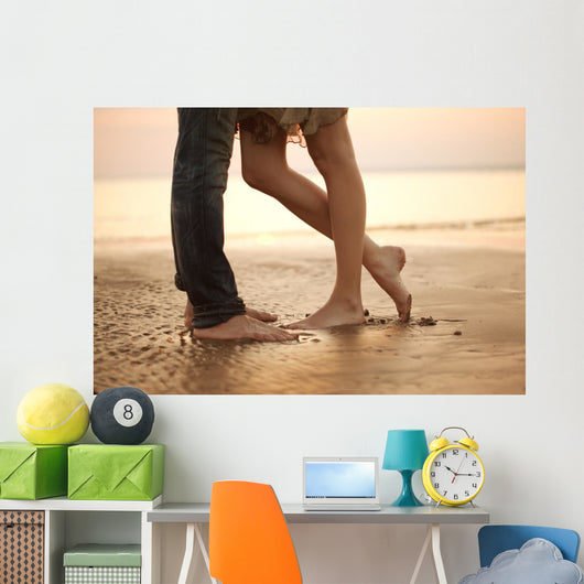A loving young couple hugging and kissing on the beach. Lovers m Wall Mural