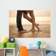A loving young couple hugging and kissing on the beach. Lovers m Wall Mural