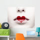 Close up of female lips with red heart shape painted on it 