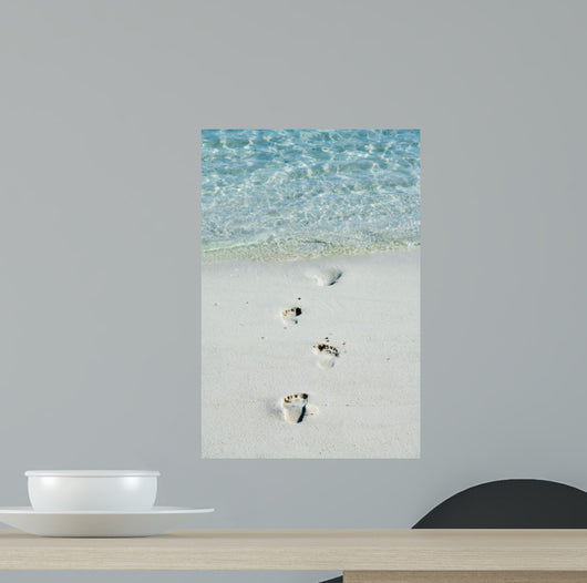 Footprints on a white beach 