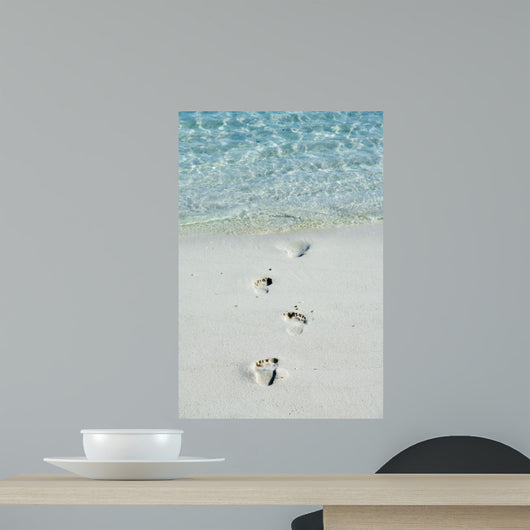 Footprints on a white beach 