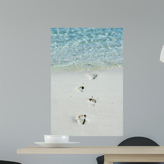 Footprints on a white beach 