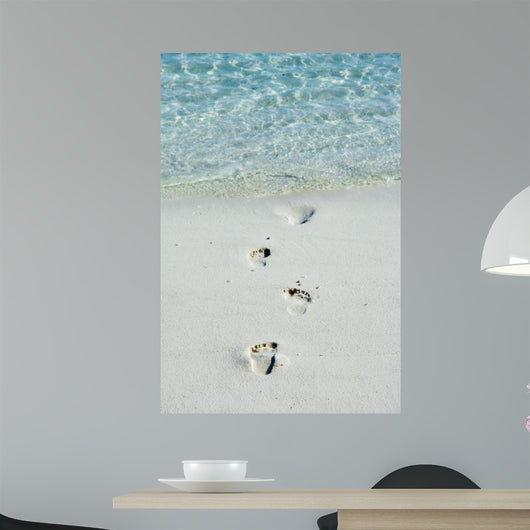 Footprints on a white beach 