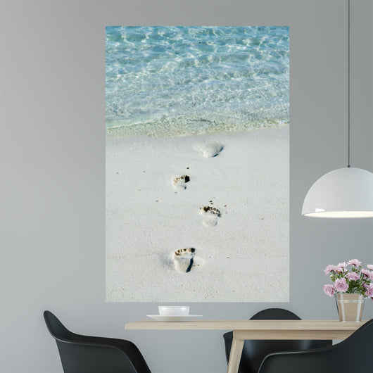 Footprints on a white beach 